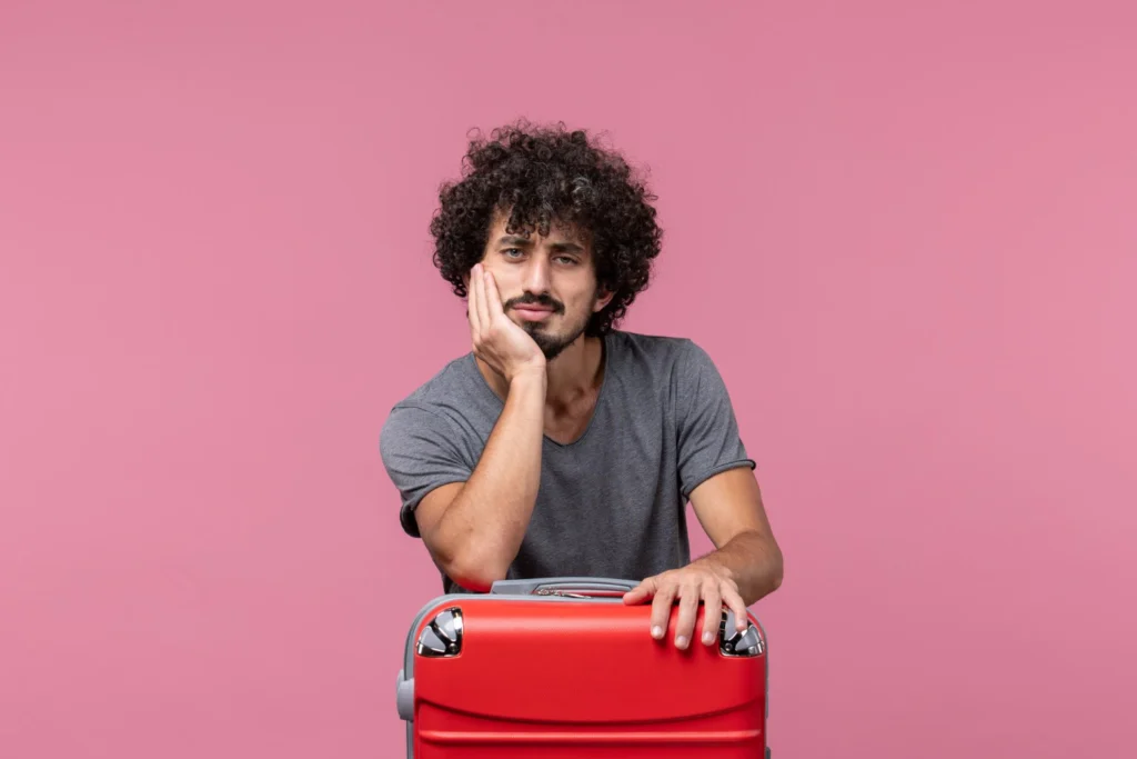 Front view young male preparing for trip with bag on light pink space