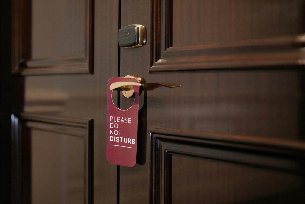 Sign board on a hotel room gate showing do not disturb
