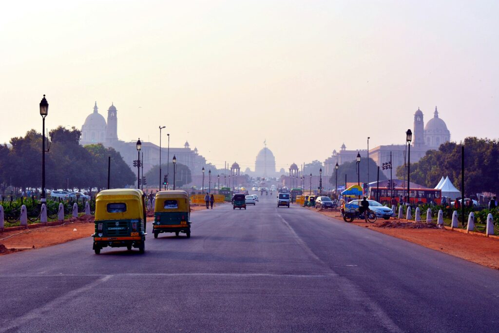 Auto Rickshaw driving on Rajpath in Delhi during daytime