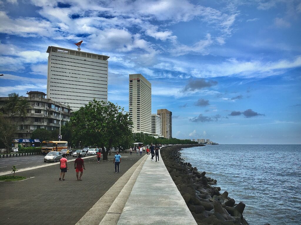 People walking on side walk on Marine Drive in Mumbai